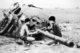 Vietnam: NLF children sawing barrel off destroyed US tank, Cu Chi, 1968